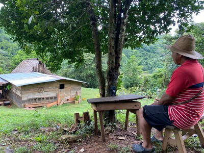 community leader Manolo taking a call with SOMO