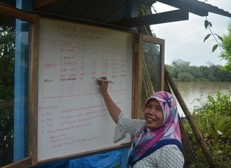 8 - A member of Kampai updates the public notice board with today’s results